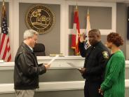 Mayor John Ernst administers the oath of office for Deputy Chief Jerry Lewis